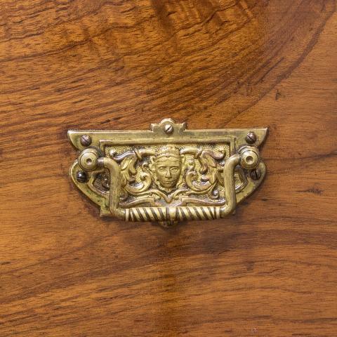 Ornate handle with a cheeky face